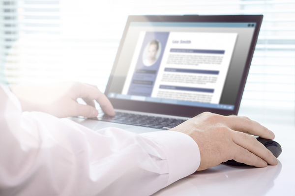 Person typing on a laptop computer.